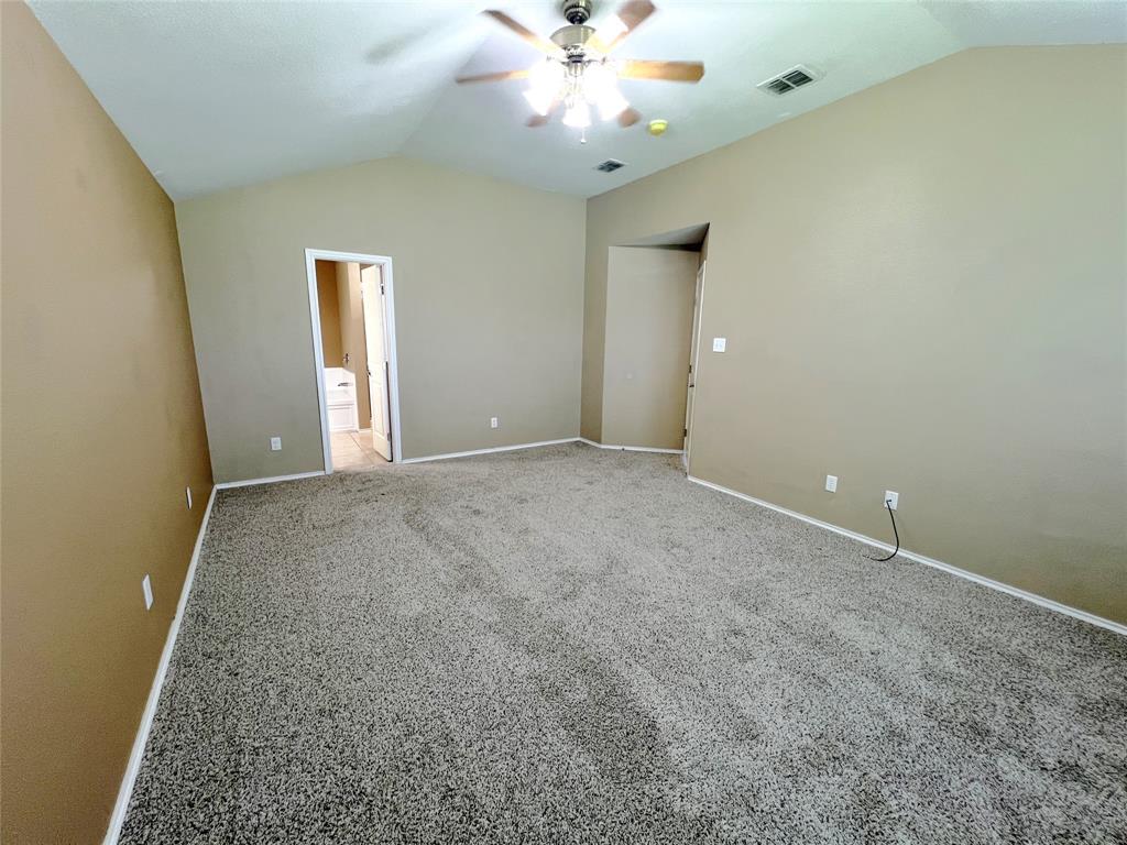 8813 Chisholm Trail Cross Roads, TX 76227 - Photo 11 of 24 an empty room with a chandelier fan and windows