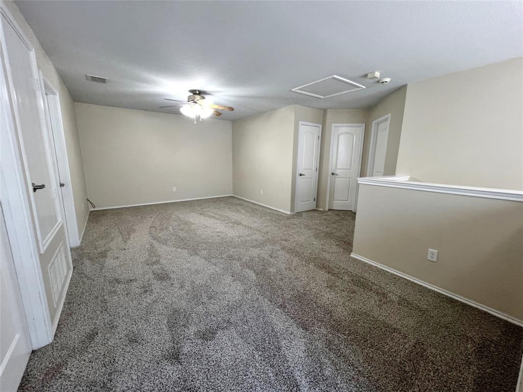 8813 Chisholm Trail Cross Roads, TX 76227 - Photo 14 of 24 en empty room with windows and fan