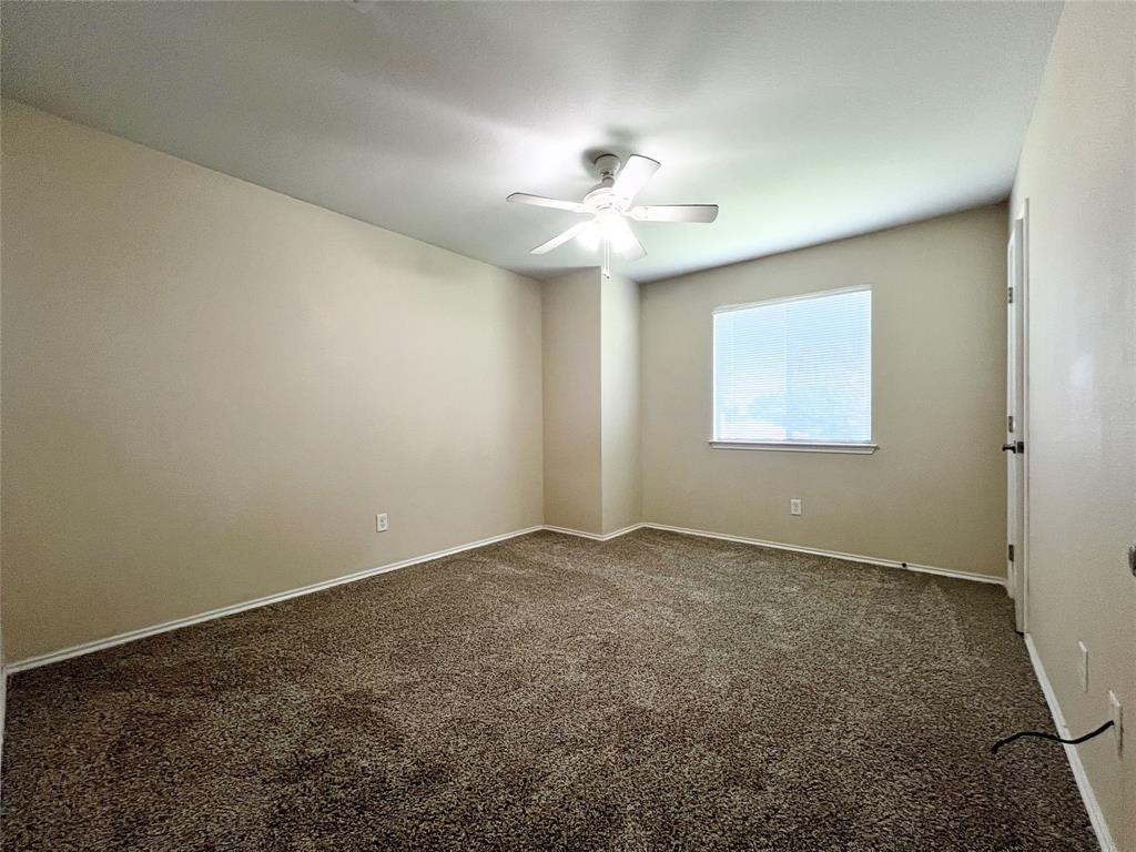 8813 Chisholm Trail Cross Roads, TX 76227 - Photo 17 of 24 an empty room with a window and a fan