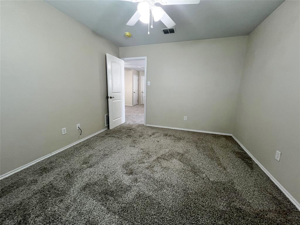 8813 Chisholm Trail Cross Roads, TX 76227 - Photo 18 of 24 an empty room with a chandelier fan and wooden floor