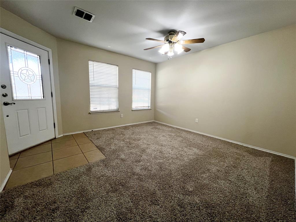 8813 Chisholm Trail Cross Roads, TX 76227 - Photo 2 of 24 an empty room with windows and chandelier fan