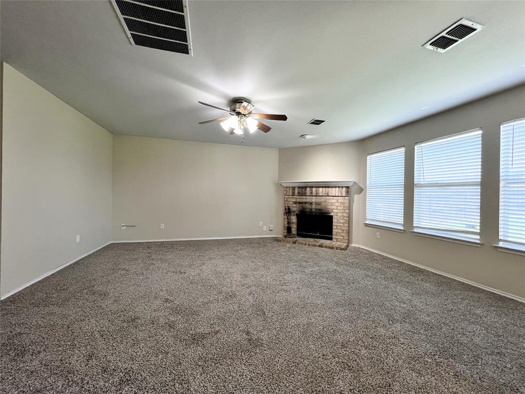 8813 Chisholm Trail Cross Roads, TX 76227 - Photo 4 of 24 a view of empty room with a fireplace