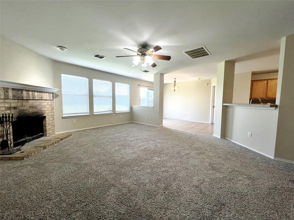 8813 Chisholm Trail Cross Roads, TX 76227 - Photo 5 of 24 a view of empty room with a fireplace and fan