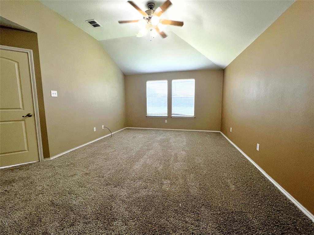 8813 Chisholm Trail Cross Roads, TX 76227 - Photo 10 of 24 an empty room with windows and fan