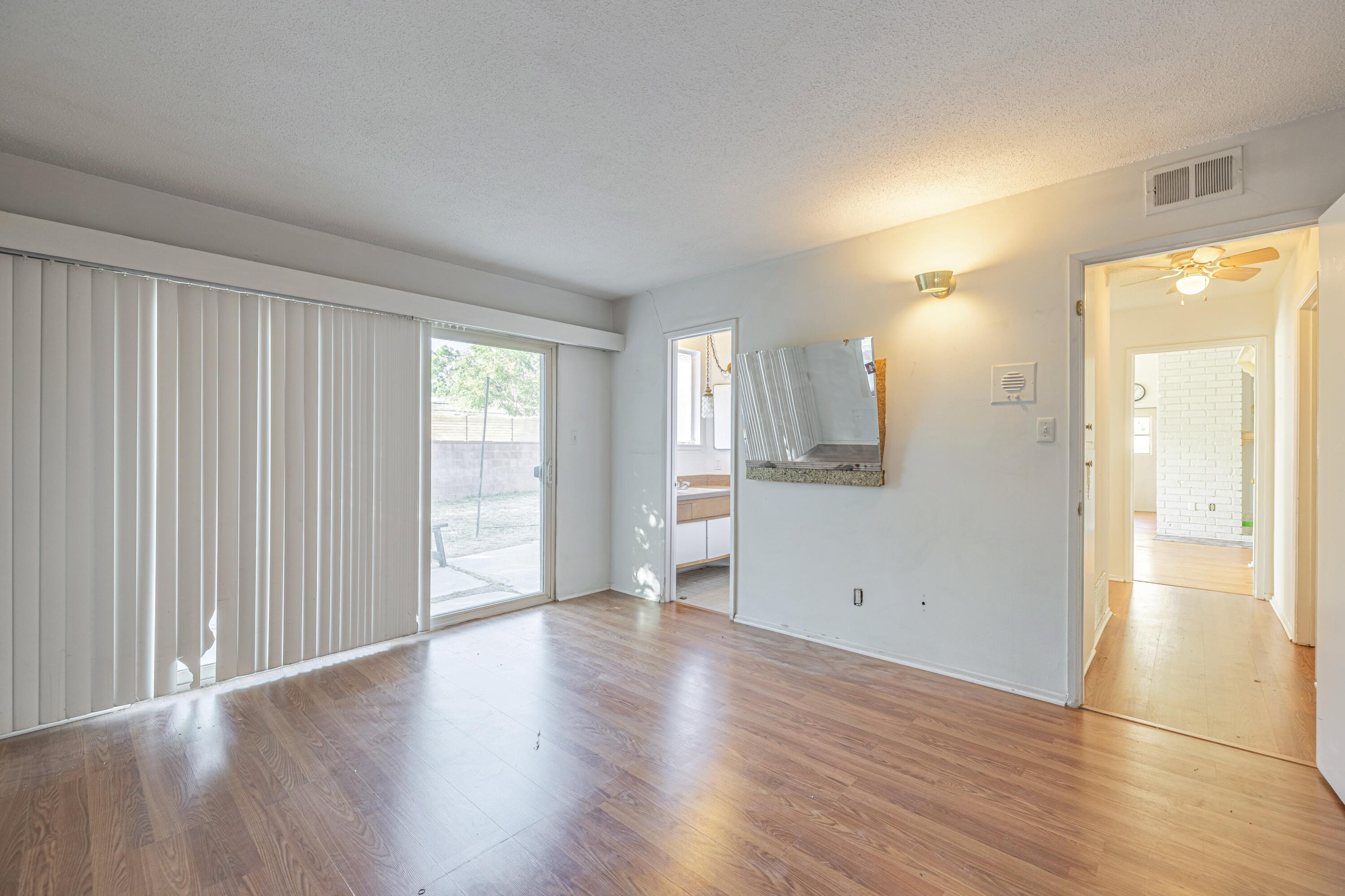 1108 Valiant Street Lancaster, CA 93534 - Photo 15 of 21 a view of an empty room with wooden floor and a window