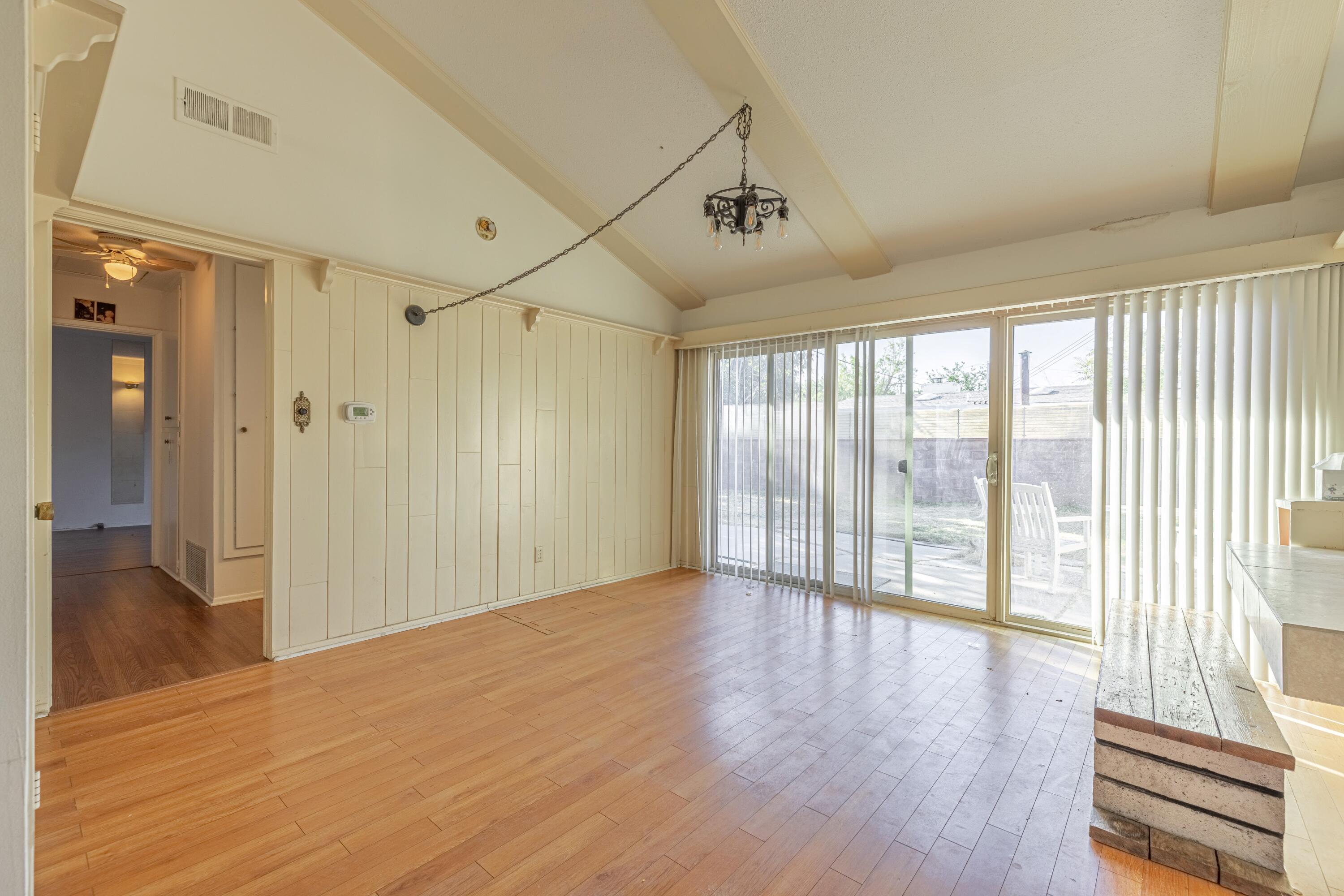 1108 Valiant Street Lancaster, CA 93534 - Photo 3 of 21 a view of an empty room with wooden floor and a window
