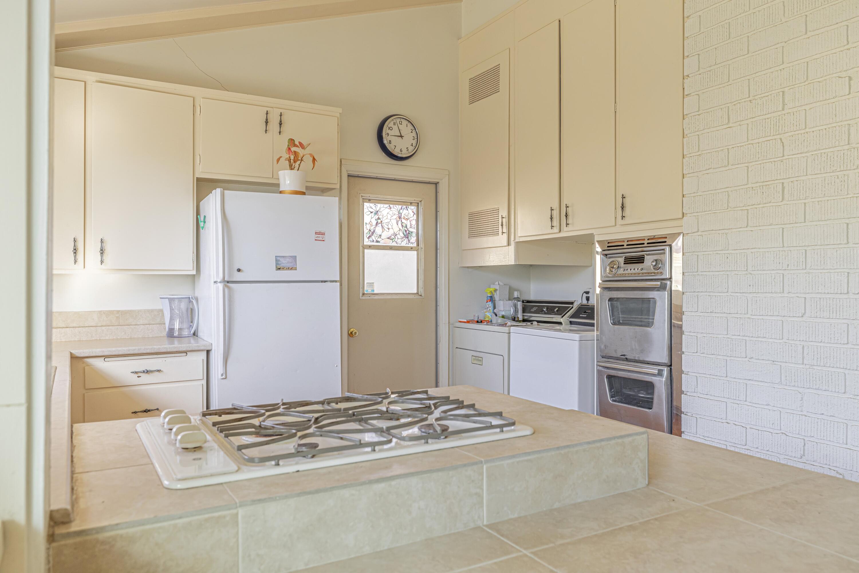 1108 Valiant Street Lancaster, CA 93534 - Photo 10 of 21 a kitchen with stainless steel appliances granite countertop a refrigerator and a stove top oven