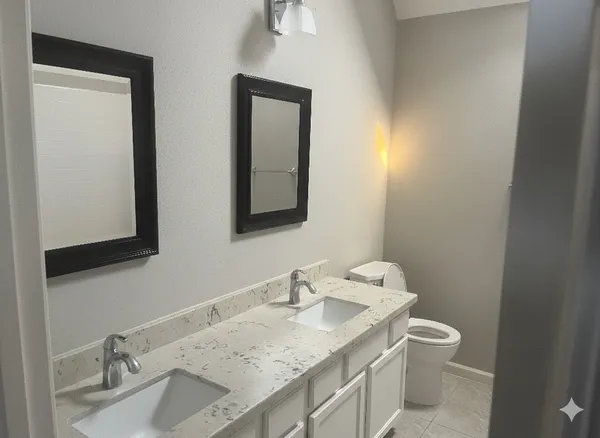 a bathroom with a granite countertop sink vanity and a mirror