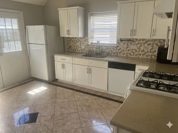 a kitchen with cabinets and appliances