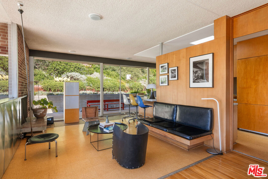 1531 North Tigertail Road Los Angeles, CA 90049 - Photo 14 of 24 a living room with patio furniture and a floor to ceiling window