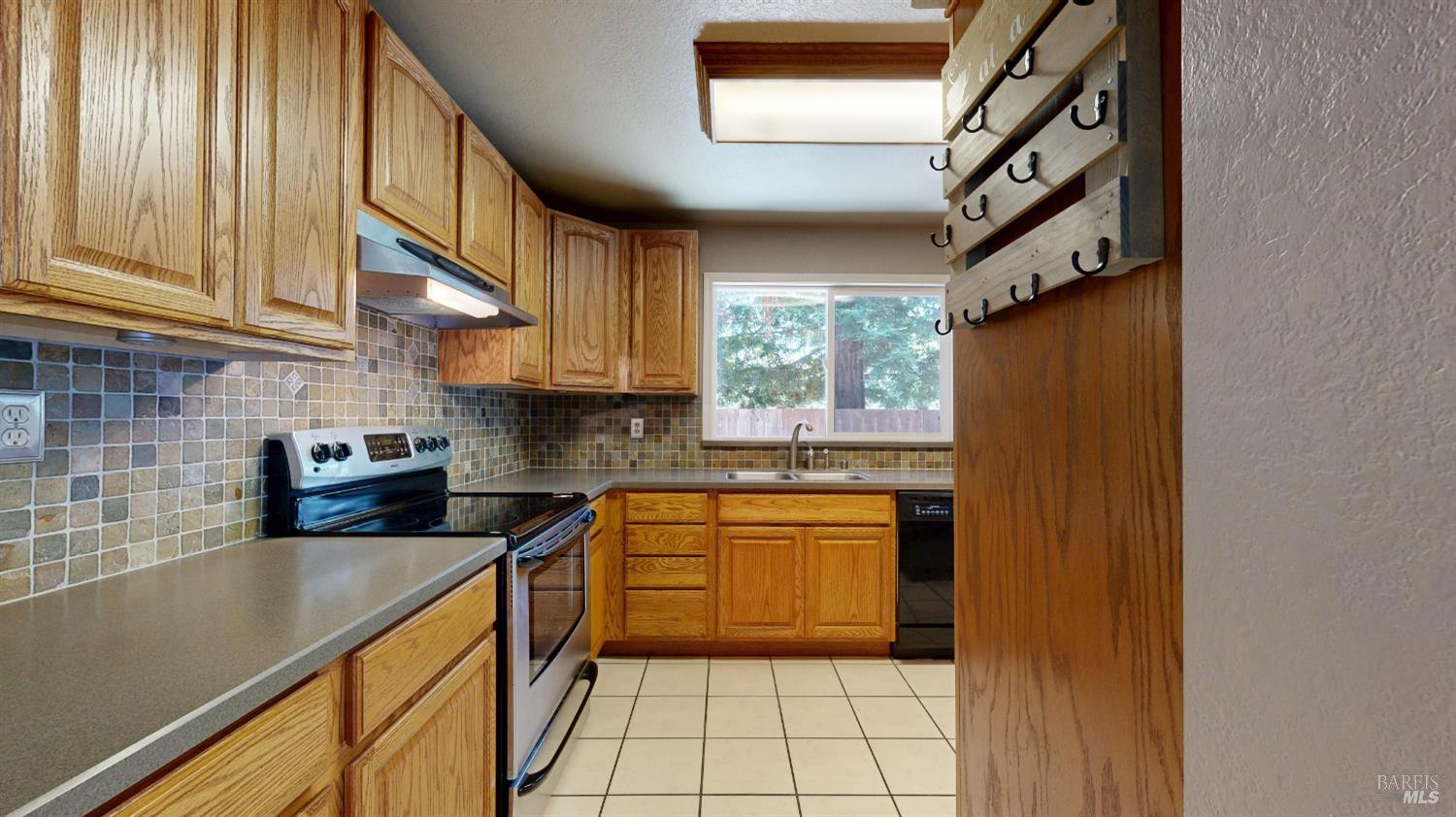 4571 Harbor Lane Rohnert Park, CA 94928 - Photo 16 of 79 a kitchen with stainless steel appliances granite countertop a refrigerator and a sink