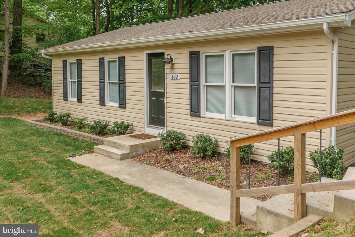 482 Round Up Road Lusby, MD 20657 - Photo 1 of 19 a front view of a house with garden