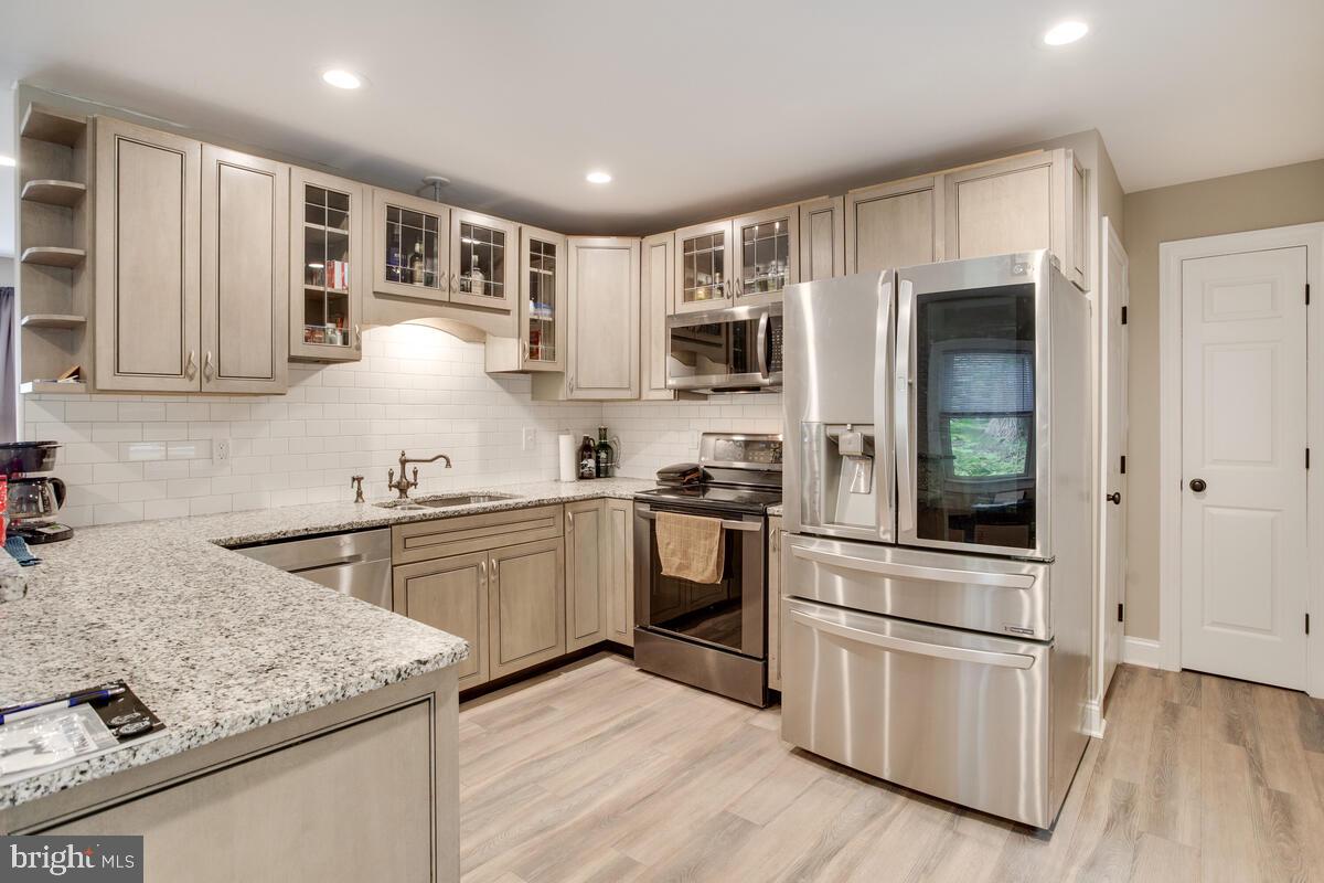 482 Round Up Road Lusby, MD 20657 - Photo 4 of 19 a kitchen with granite countertop stainless steel appliances and sink
