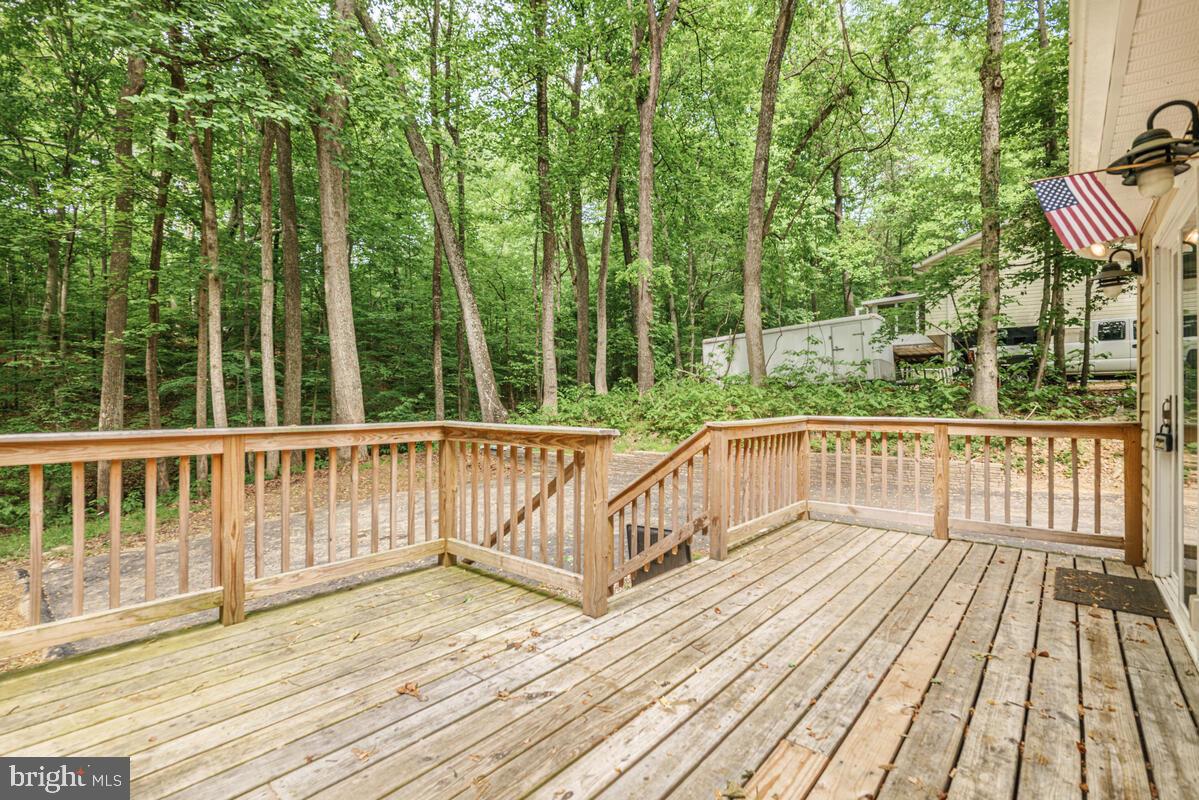 482 Round Up Road Lusby, MD 20657 - Photo 5 of 19 a balcony with wooden floor and fence