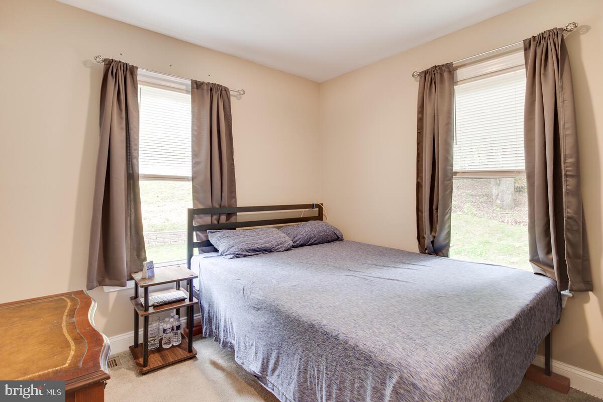 482 Round Up Road Lusby, MD 20657 - Photo 8 of 19 a bedroom with a bed and a window