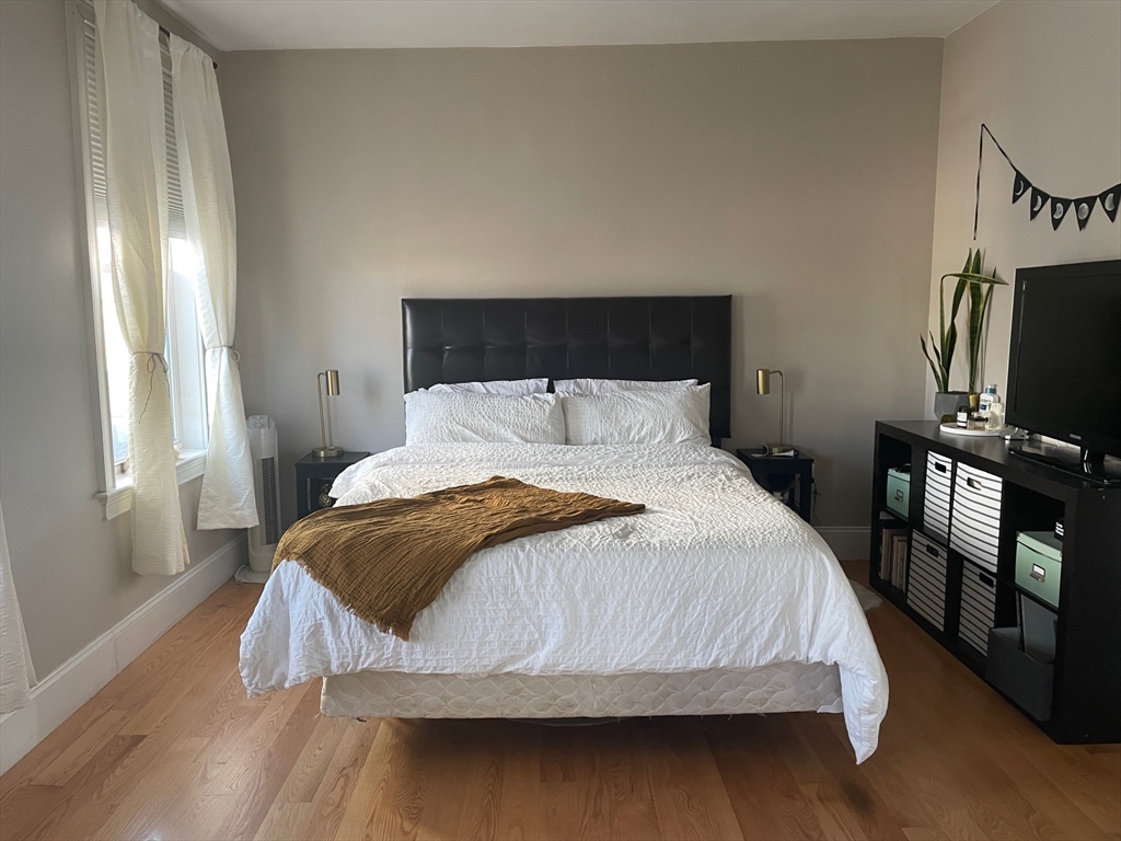 227 Bowen Street, Unit 3 Boston, MA 02127 - Photo 6 of 9 a bedroom with a bed and a flat screen tv