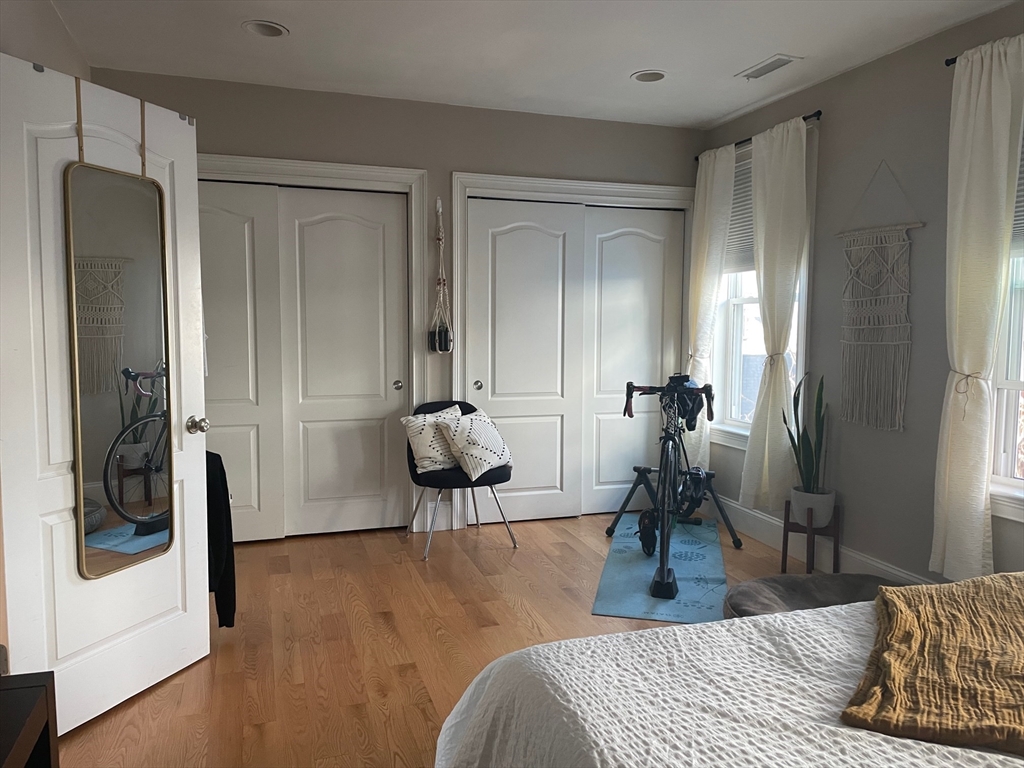 227 Bowen Street, Unit 3 Boston, MA 02127 - Photo 7 of 9 a bedroom with a bed and a mirror