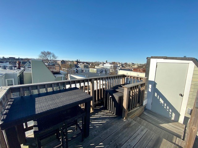 227 Bowen Street, Unit 3 Boston, MA 02127 - Photo 9 of 9 a view of a balcony with wooden chairs