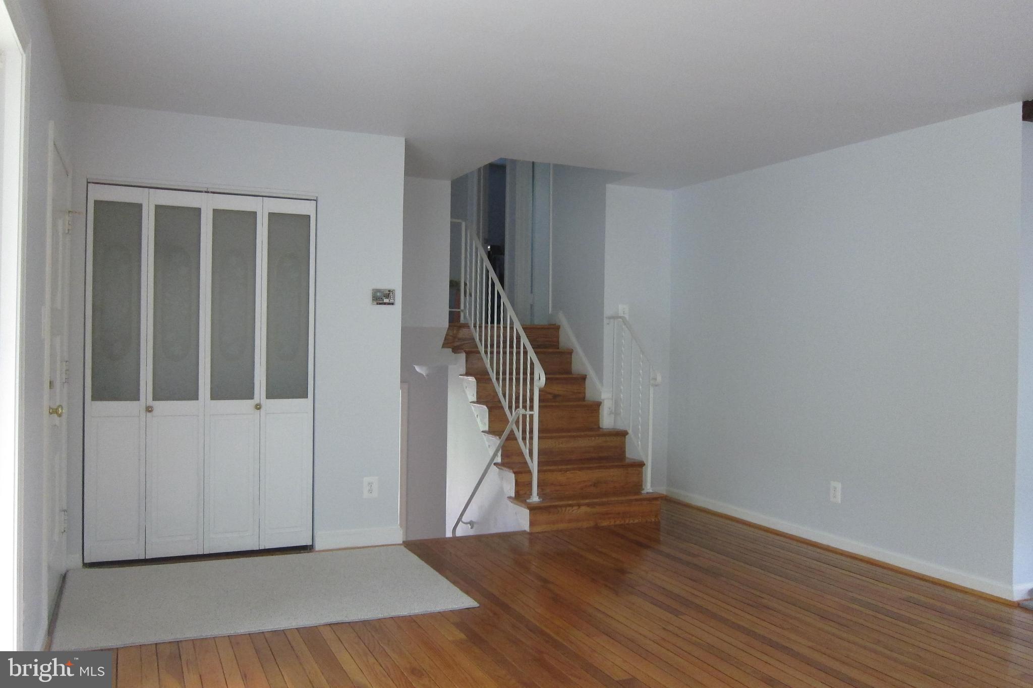 8225 Crown Court Road Alexandria, VA 22308 - Photo 5 of 57 Living room closet, stairs to Upper/ Lower levels