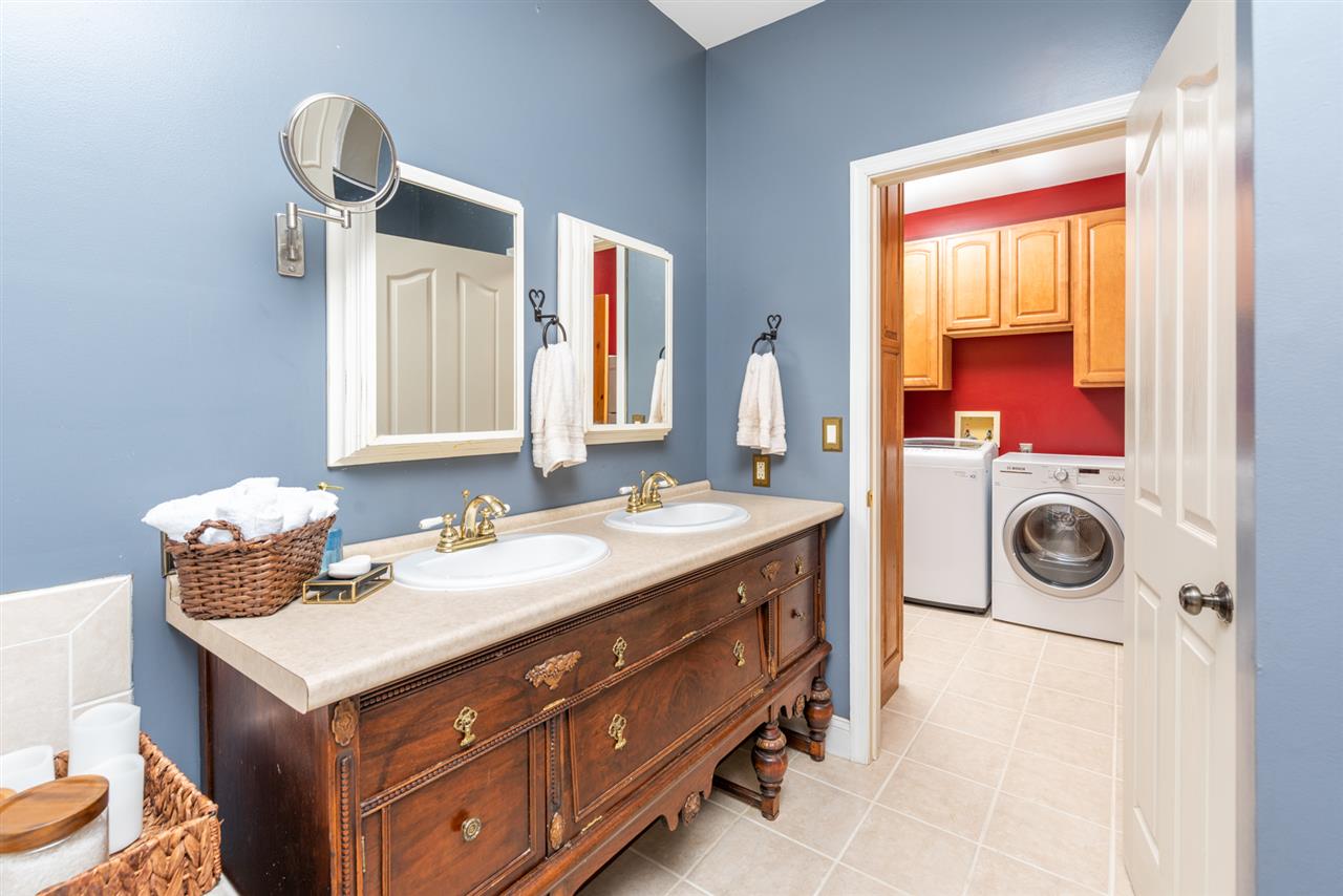 975 Limestone Road Mount Sidney, VA 24467 - Photo 23 of 49 a bathroom with a sink vanity and a mirror