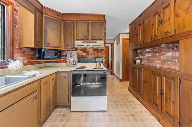 a kitchen with stainless steel appliances a refrigerator and a stove top oven