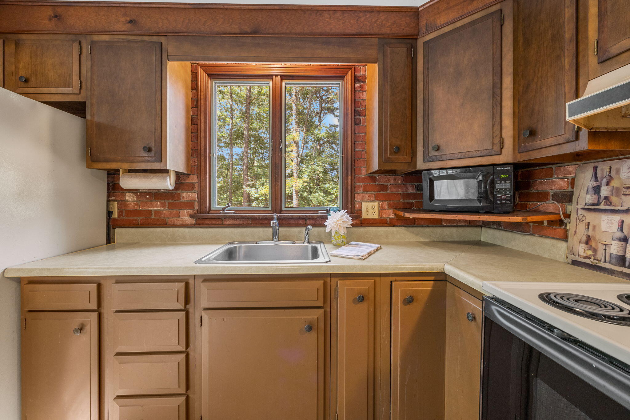 65 Cestaro Way Eastham, MA 02642 - Photo 15 of 40 a kitchen with stainless steel appliances granite countertop a sink a stove and a microwave