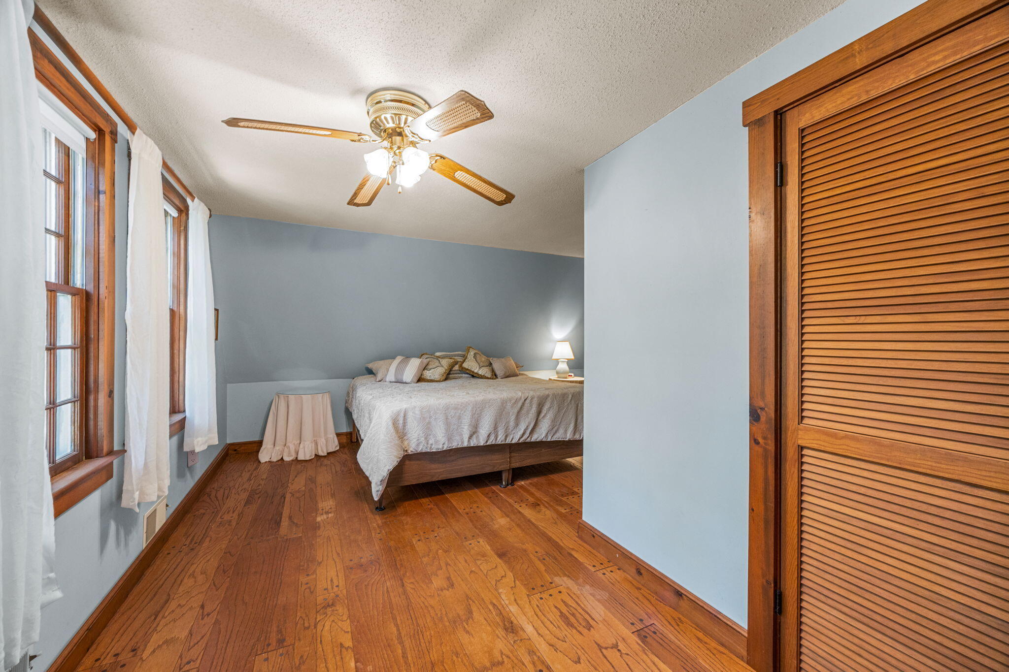 65 Cestaro Way Eastham, MA 02642 - Photo 23 of 40 a bedroom with a bed and wooden floor