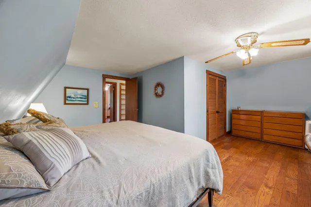 a bedroom with a bed and a dresser