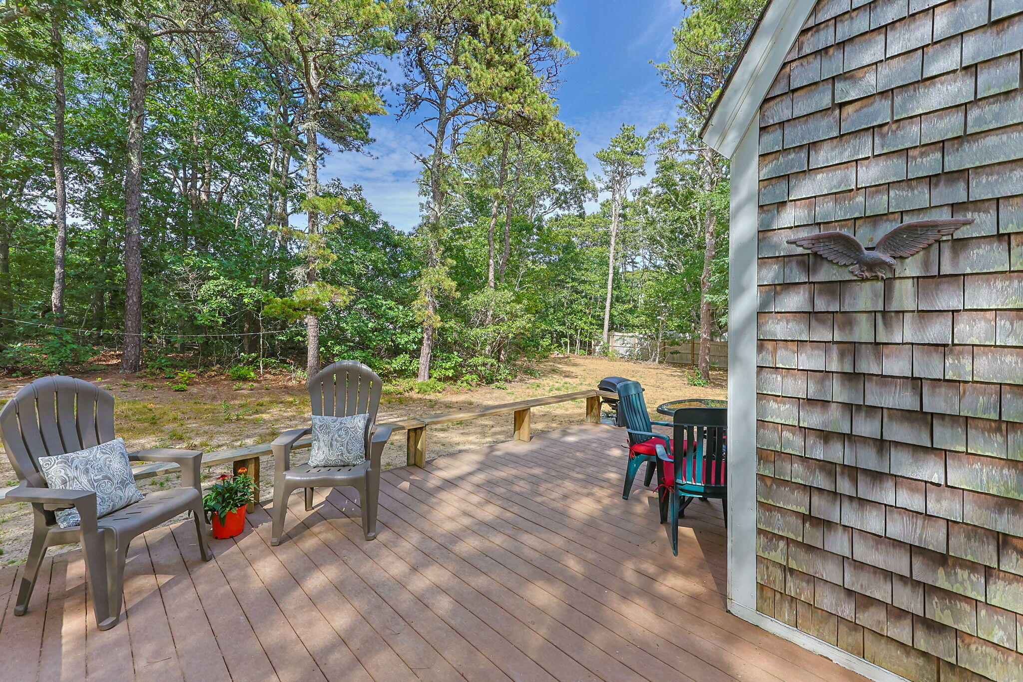 65 Cestaro Way Eastham, MA 02642 - Photo 28 of 40 a view of a patio with a table and chairs