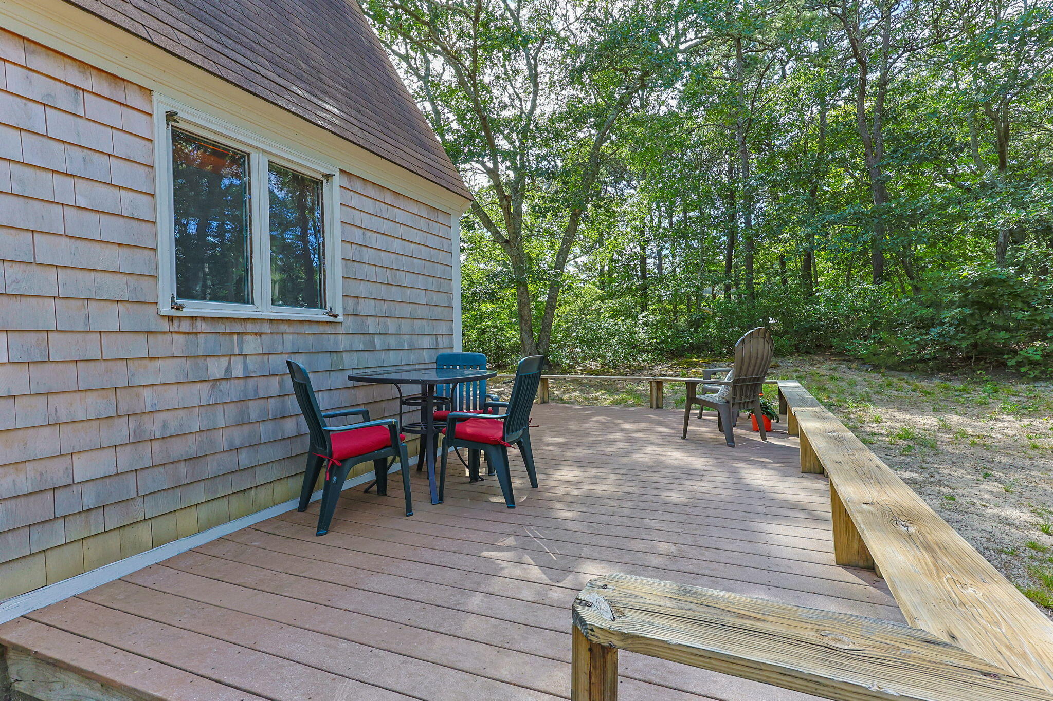 65 Cestaro Way Eastham, MA 02642 - Photo 29 of 40 a view of a dinning table and chairs in patio of the house