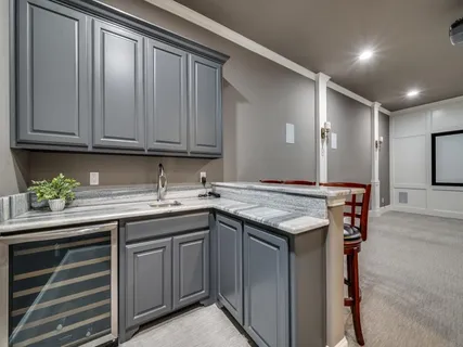 a view of an empty room with wooden floor and a projector