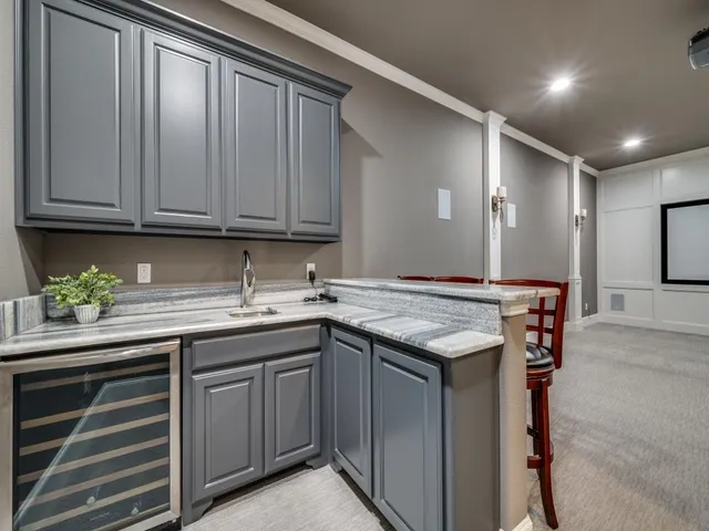 a view of an empty room with wooden floor and a projector