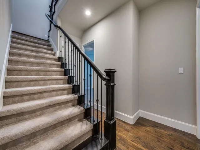 a spacious bedroom with a bed and a television