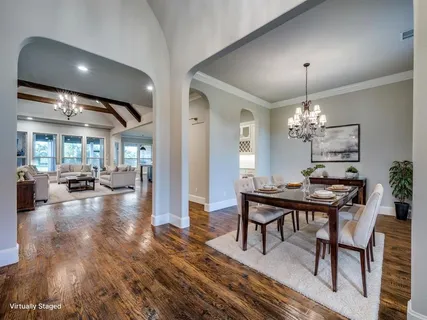 a view of a dining room with furniture and chandelier
