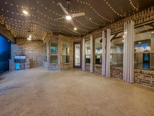 a view of an empty room with a fireplace and a flat screen tv