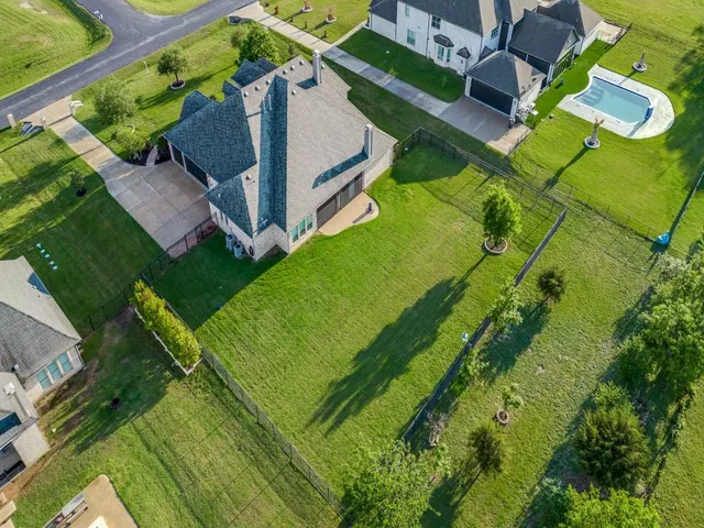 an aerial view of a house with a yard