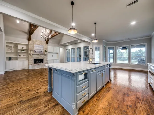 a spacious bedroom with a large bed and a chandelier