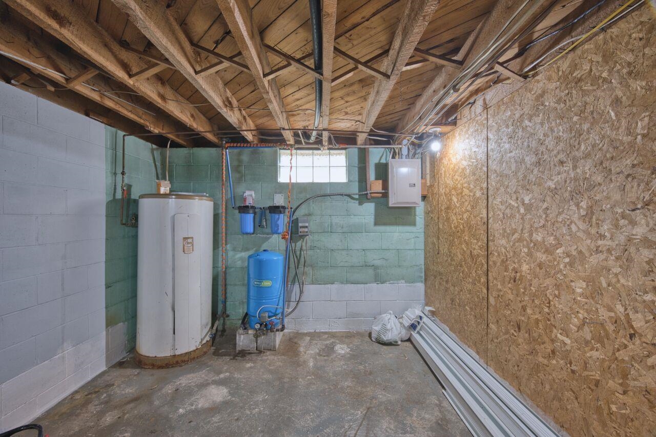 5462 Twin Lakes Loop 45 Aurora, MN 55705 - Photo 20 of 42 Below grade area with water heater, a water pressure tank, and electric panel