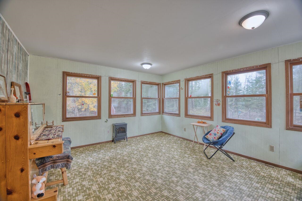 5462 Twin Lakes Loop 45 Aurora, MN 55705 - Photo 3 of 42 Sitting room featuring carpet floors and a wood stove