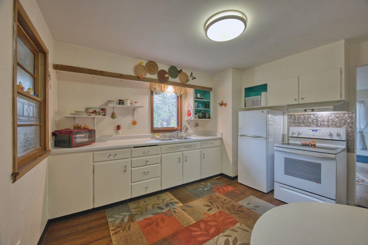 5462 Twin Lakes Loop 45 Aurora, MN 55705 - Photo 7 of 42 Kitchen with open shelves, white cabinetry, white appliances, and light countertops