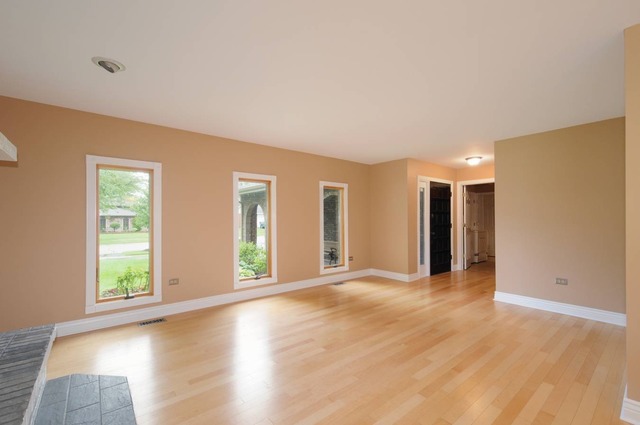 298 Mulberry Road Frankfort, IL 60423 - Photo 6 of 10 a view of an empty room with window and wooden floor