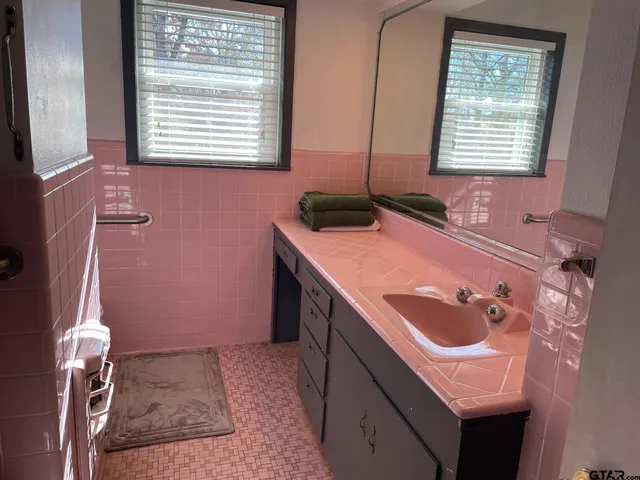 a bathroom with a sink and a window