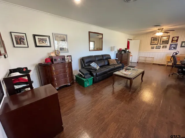 a living room with furniture window and wooden floor