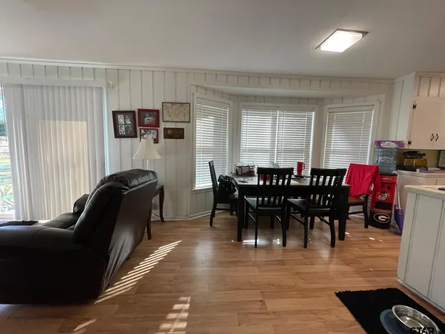 a view of a dining room with furniture and window