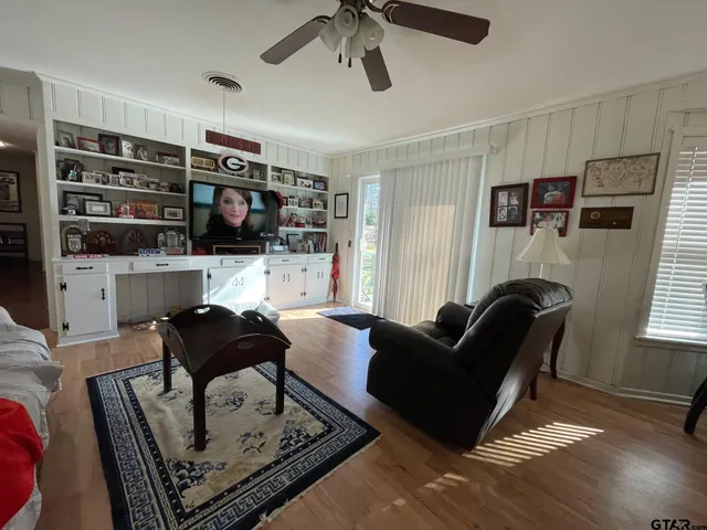 a living room with furniture a rug and a flat screen tv