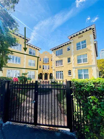 a front view of a building with a garden