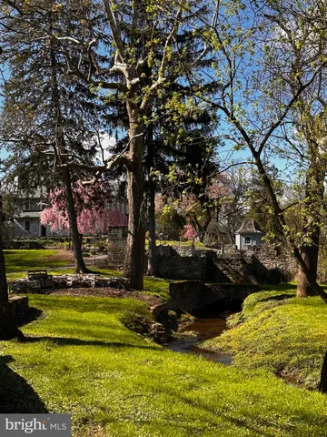 a view of swimming pool with outdoor seating and trees
