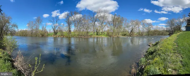 a view of a lake in between two of trees