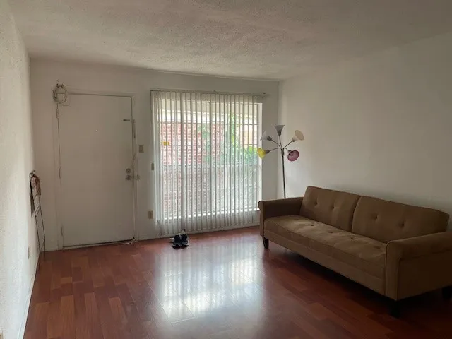 a living room with furniture and a floor to ceiling window