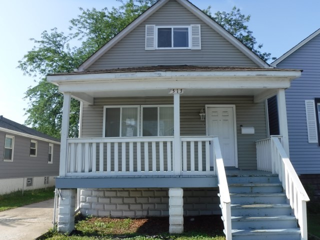 a front view of a house with wooden stairs